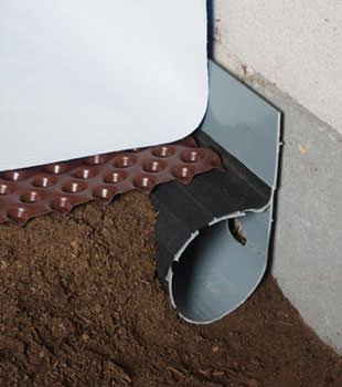 Closeup of a crawl space drainage system installed in Aldie