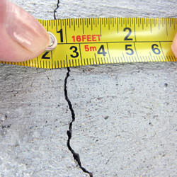 A crack in a poured concrete wall that's showing a normal crack during curing in Falls Church