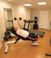 a basement gym and workout room with a wood laminate flooring, installed in Fredericksburg, VA
